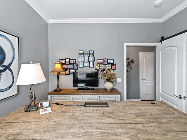 interior space with a barn door and crown molding