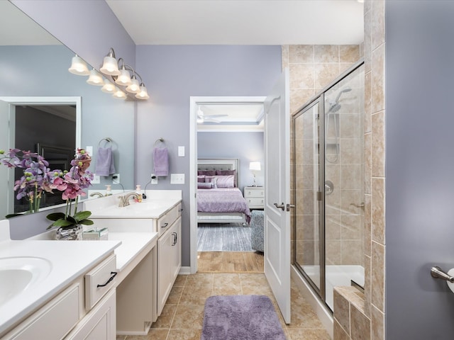 ensuite bathroom with a shower stall, ceiling fan, ensuite bath, and vanity