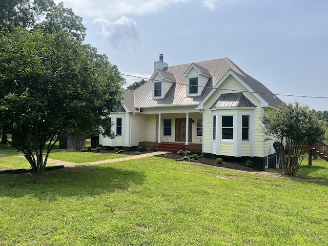 612 Jesse Work Rd, Dickson, TN 37055 - cape cod-style house featuring a porch, metal roof, a chimney, and a front yard