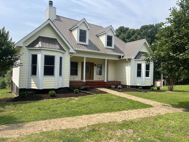 612 Jesse Work Rd, Dickson, TN 37055 - view of front of house featuring covered porch, metal roof, a front yard, and a chimney