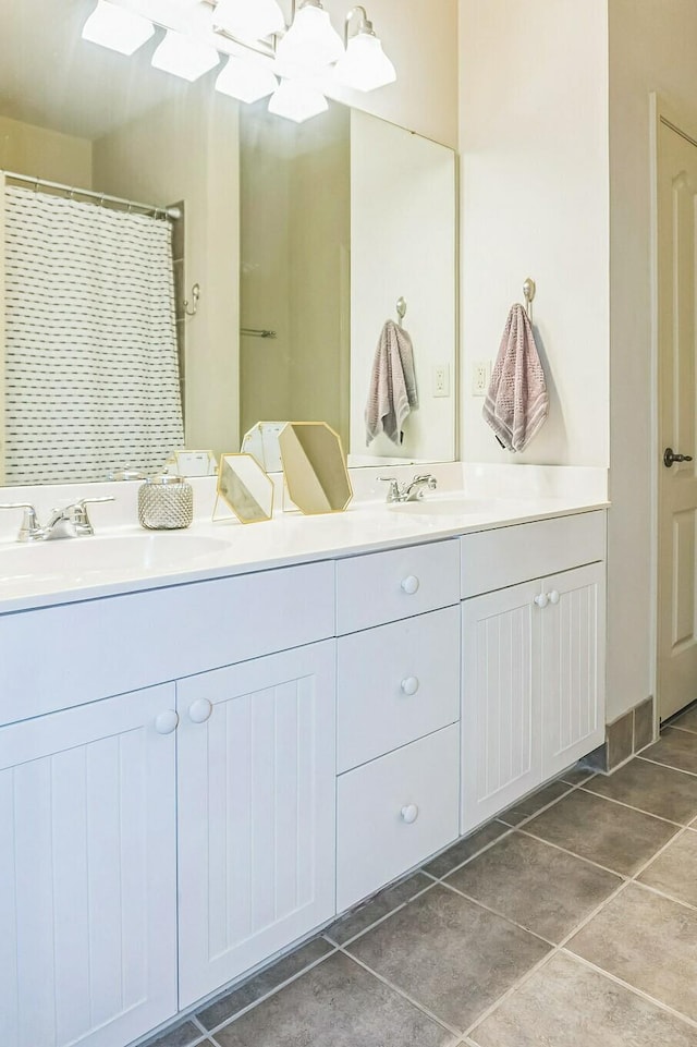 full bathroom with tile patterned flooring, a sink, and double vanity