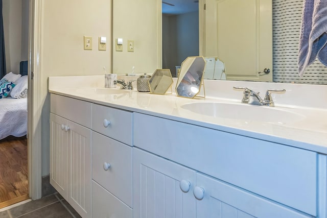 full bath with tile patterned floors, ensuite bath, a sink, and double vanity