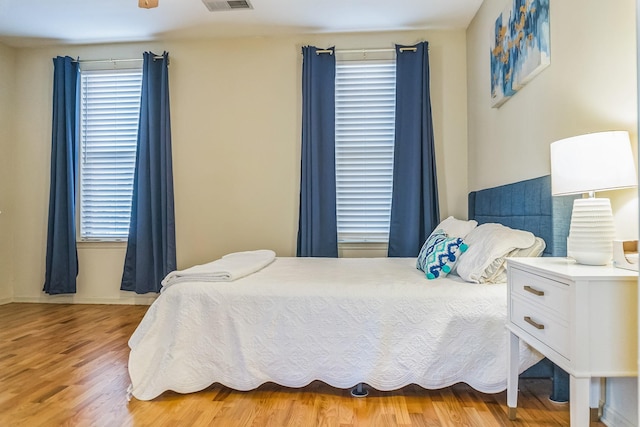 bedroom featuring visible vents and light wood-style floors