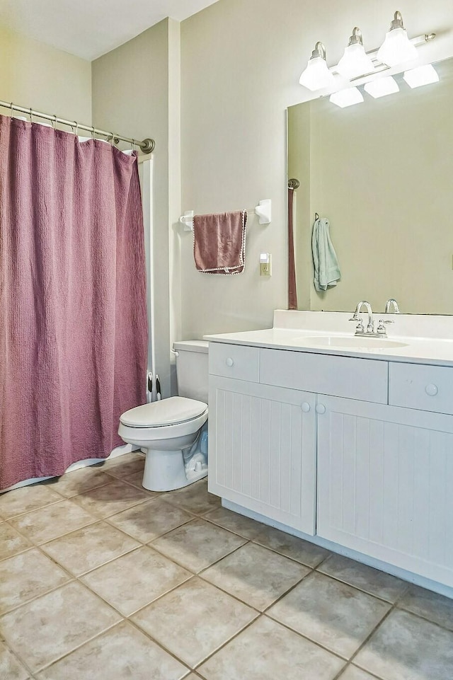 bathroom featuring a shower with curtain, tile patterned floors, vanity, and toilet