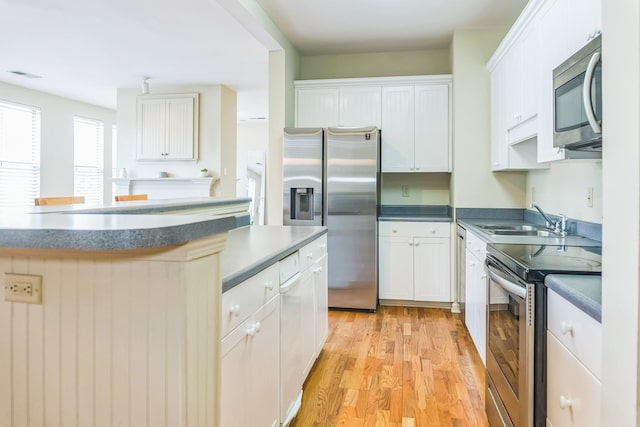 kitchen featuring white cabinetry, appliances with stainless steel finishes, a sink, and visible vents