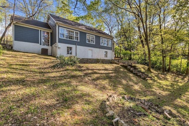 back of property featuring a yard