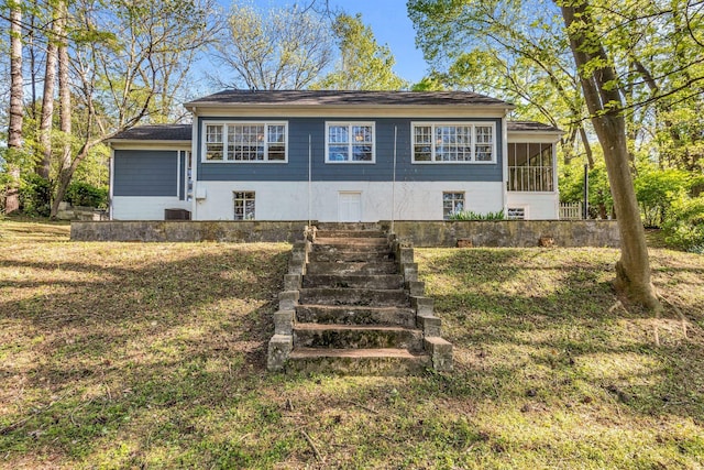 view of front of home featuring a sunroom
