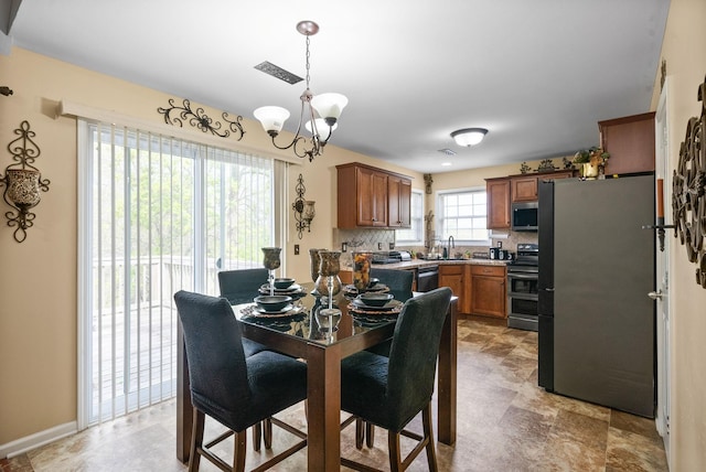 dining area featuring a notable chandelier and visible vents
