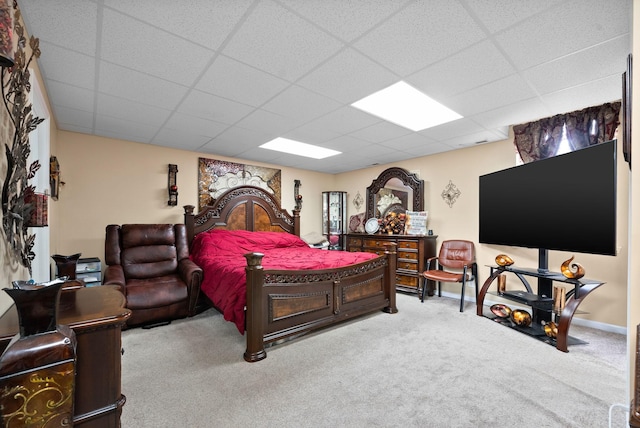 bedroom with a paneled ceiling and carpet