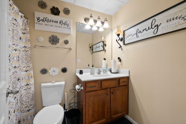bathroom featuring toilet, vanity, and a shower with shower curtain
