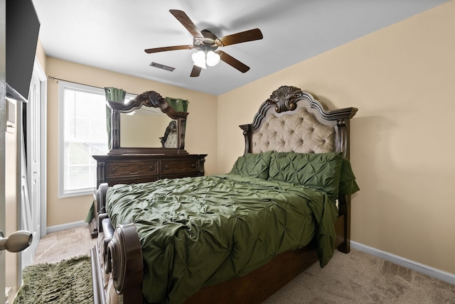 carpeted bedroom featuring visible vents, baseboards, and ceiling fan