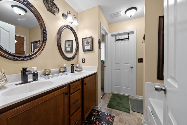 full bathroom with visible vents, a sink, and double vanity