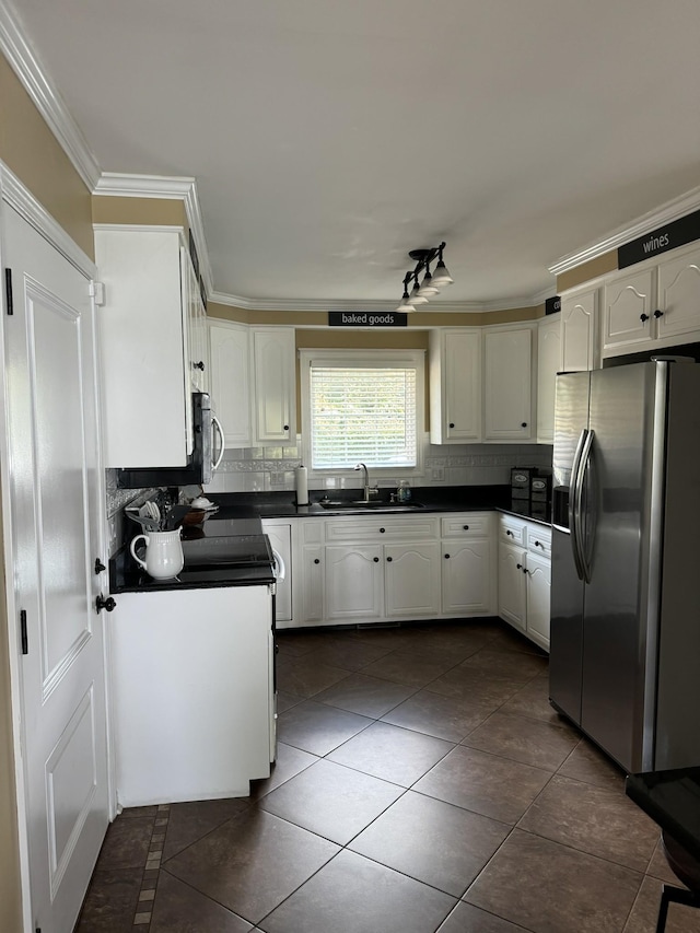 15 Cheekwood Ln, Cadiz, KY 42211 - kitchen featuring a sink, tasteful backsplash, dark countertops, dark tile patterned flooring, and appliances with stainless steel finishes