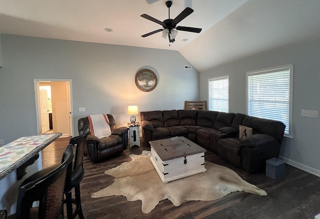 living area featuring vaulted ceiling, baseboards, visible vents, a ceiling fan, and dark wood-type flooring