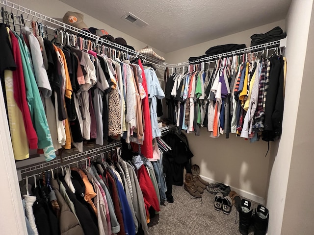 walk in closet with visible vents and carpet flooring