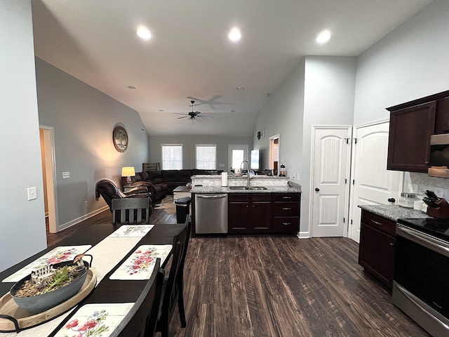 kitchen with dark wood finished floors, lofted ceiling, dark brown cabinets, a ceiling fan, and appliances with stainless steel finishes