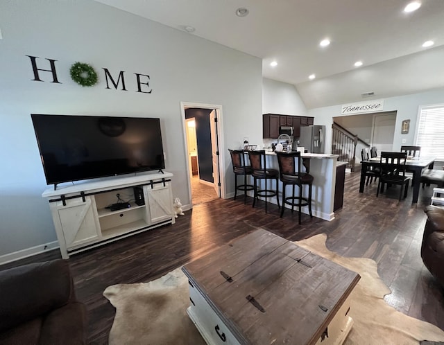 living room featuring baseboards, lofted ceiling, stairs, and dark wood-style floors