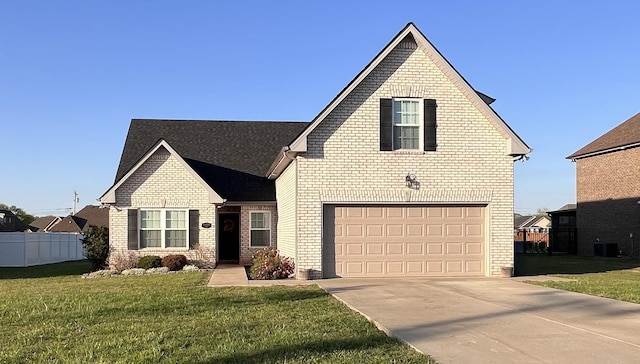 traditional home with concrete driveway, an attached garage, brick siding, and a front yard