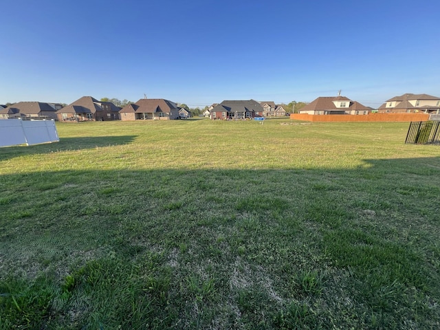 view of yard with fence and a residential view