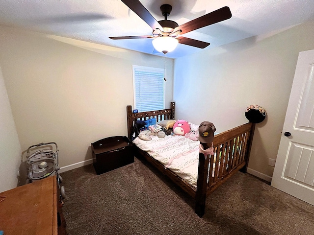 carpeted bedroom with ceiling fan and baseboards