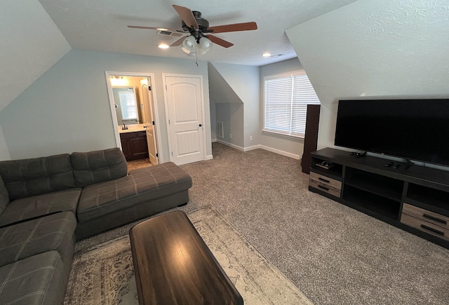 living area featuring ceiling fan, carpet floors, lofted ceiling, and baseboards