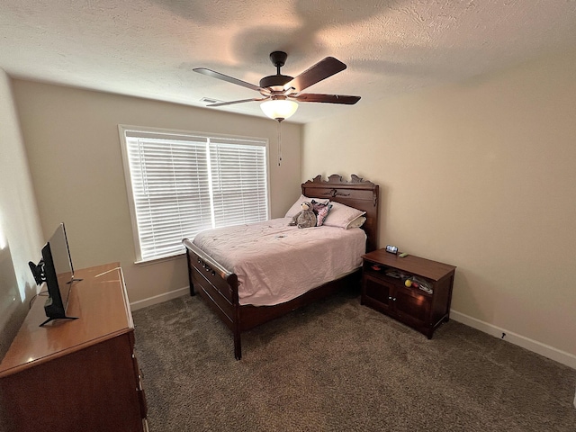 carpeted bedroom featuring a ceiling fan, baseboards, and a textured ceiling
