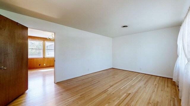 1001 Clearview Dr, Mount Juliet, TN 37122 - empty room featuring light wood finished floors, baseboards, an inviting chandelier, and visible vents