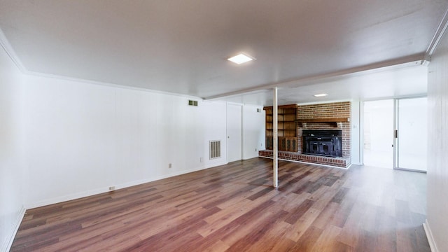 1001 Clearview Dr, Mount Juliet, TN 37122 - unfurnished living room with wood finished floors, visible vents, ornamental molding, and a brick fireplace