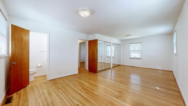 1001 Clearview Dr, Mount Juliet, TN 37122 - unfurnished bedroom with light wood-style flooring, ensuite bathroom, baseboards, visible vents, and two closets