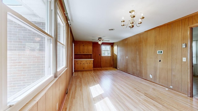 1001 Clearview Dr, Mount Juliet, TN 37122 - unfurnished dining area featuring wooden walls, light wood finished floors, and ceiling fan with notable chandelier