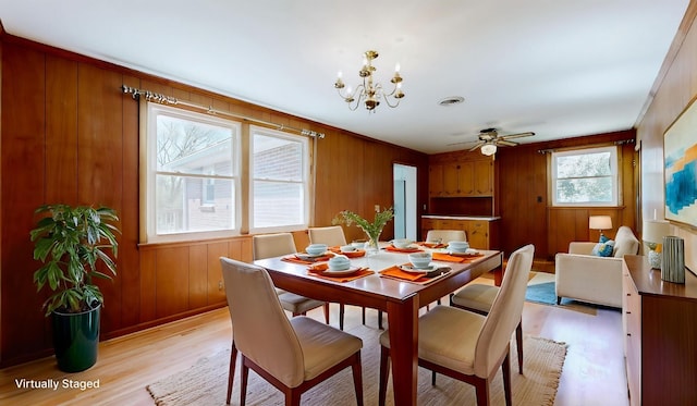1001 Clearview Dr, Mount Juliet, TN 37122 - dining area featuring wood walls, light wood-style floors, visible vents, and ceiling fan with notable chandelier