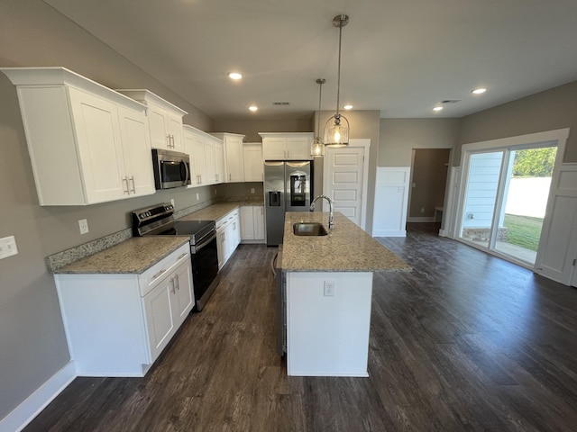 kitchen with dark wood-style flooring, baseboards, stainless steel appliances, and a sink