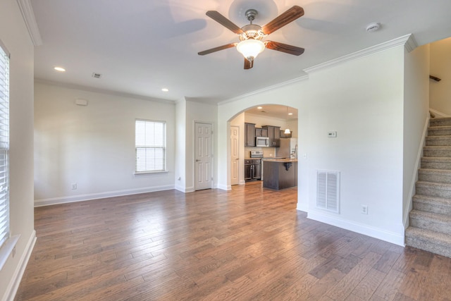 956 Innsbrooke Ave, Hendersonville, TN 37075 - unfurnished living room featuring ornamental molding, arched walkways, stairs, dark wood-type flooring, and ceiling fan