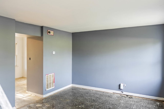empty room with baseboards and visible vents