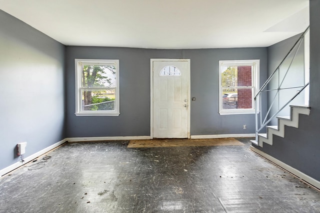 foyer with plenty of natural light, baseboards, and stairway