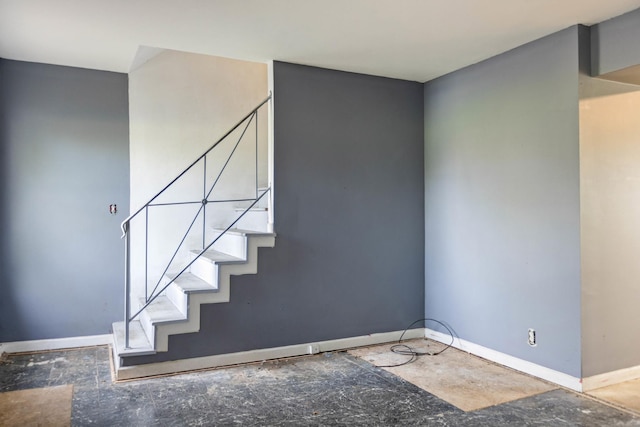 staircase featuring baseboards