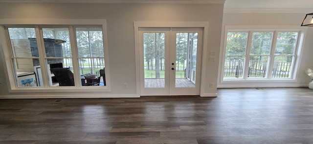 doorway to outside with baseboards, crown molding, french doors, and dark wood-style floors