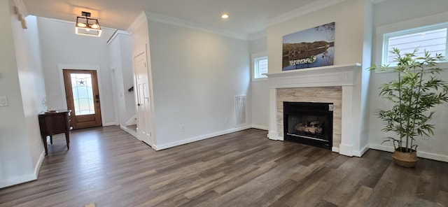 foyer featuring a fireplace, crown molding, dark wood-type flooring, and recessed lighting