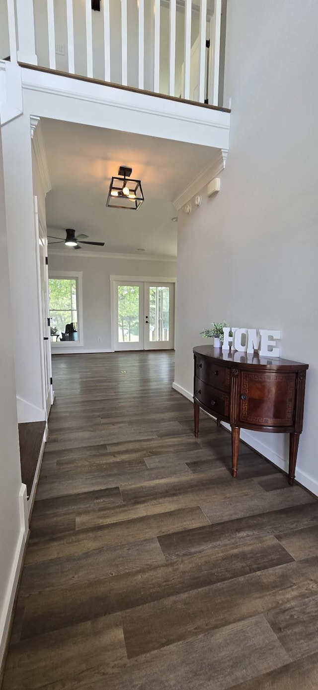 interior space with french doors, dark wood-style flooring, ceiling fan, and crown molding