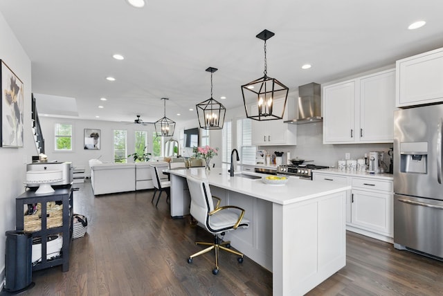 2002 Manchester Ave, Nashville, TN 37218 - kitchen with wall chimney range hood, a sink, stainless steel appliances, light countertops, and recessed lighting