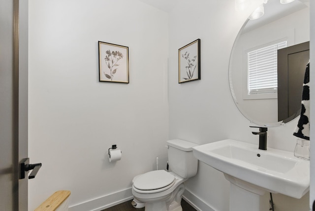 2002 Manchester Ave, Nashville, TN 37218 - half bathroom featuring baseboards, toilet, and a sink
