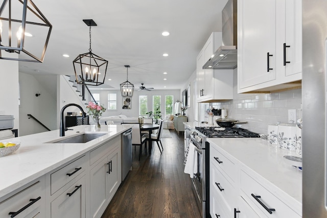 2002 Manchester Ave, Nashville, TN 37218 - kitchen featuring recessed lighting, wall chimney exhaust hood, appliances with stainless steel finishes, and a sink