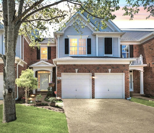 view of front facade featuring brick siding, a front lawn, concrete driveway, and an attached garage