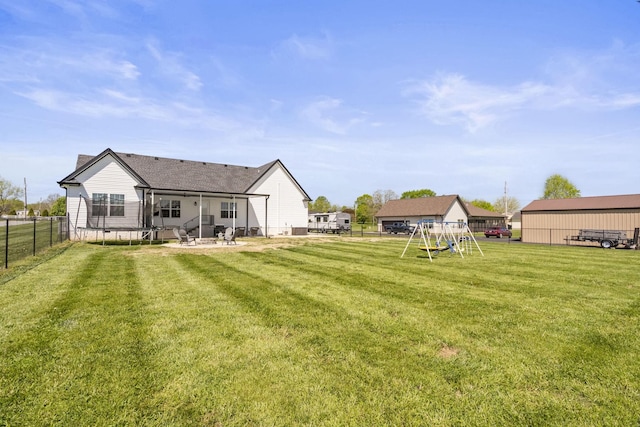 back of property with a lawn, a playground, a patio area, and a fenced backyard