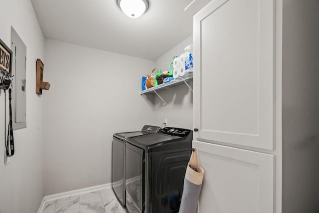 laundry area featuring separate washer and dryer, baseboards, marble finish floor, and laundry area