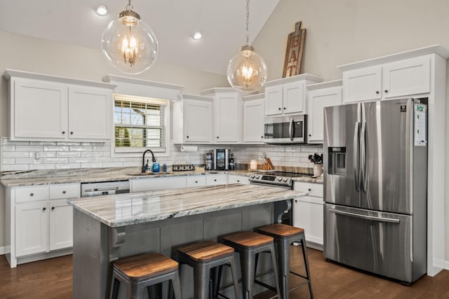 kitchen with white cabinets, stainless steel appliances, decorative backsplash, and a sink