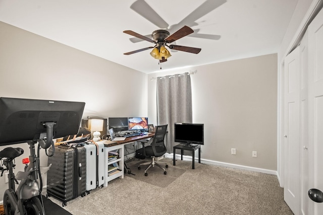 carpeted home office with baseboards and ceiling fan