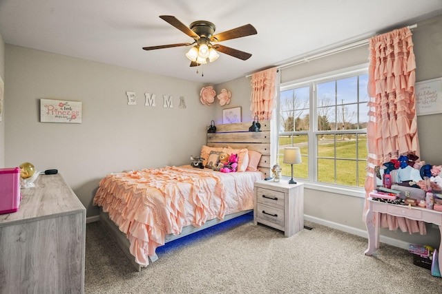 bedroom with a ceiling fan, baseboards, and carpet flooring