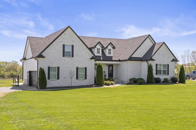 view of front facade with brick siding, a shingled roof, and a front lawn
