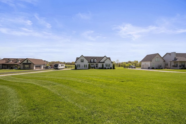 view of yard featuring an attached garage and driveway